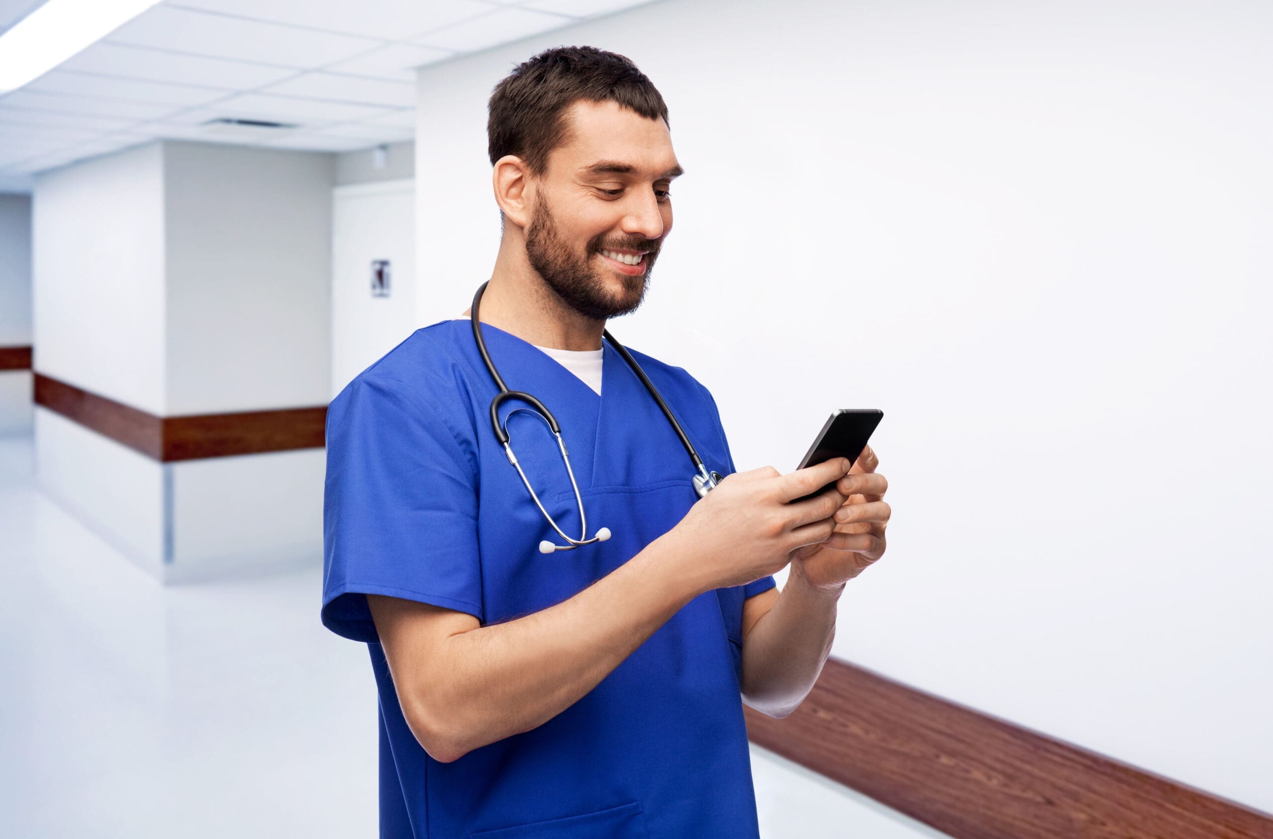 A carer looks at a phone after supporting someone