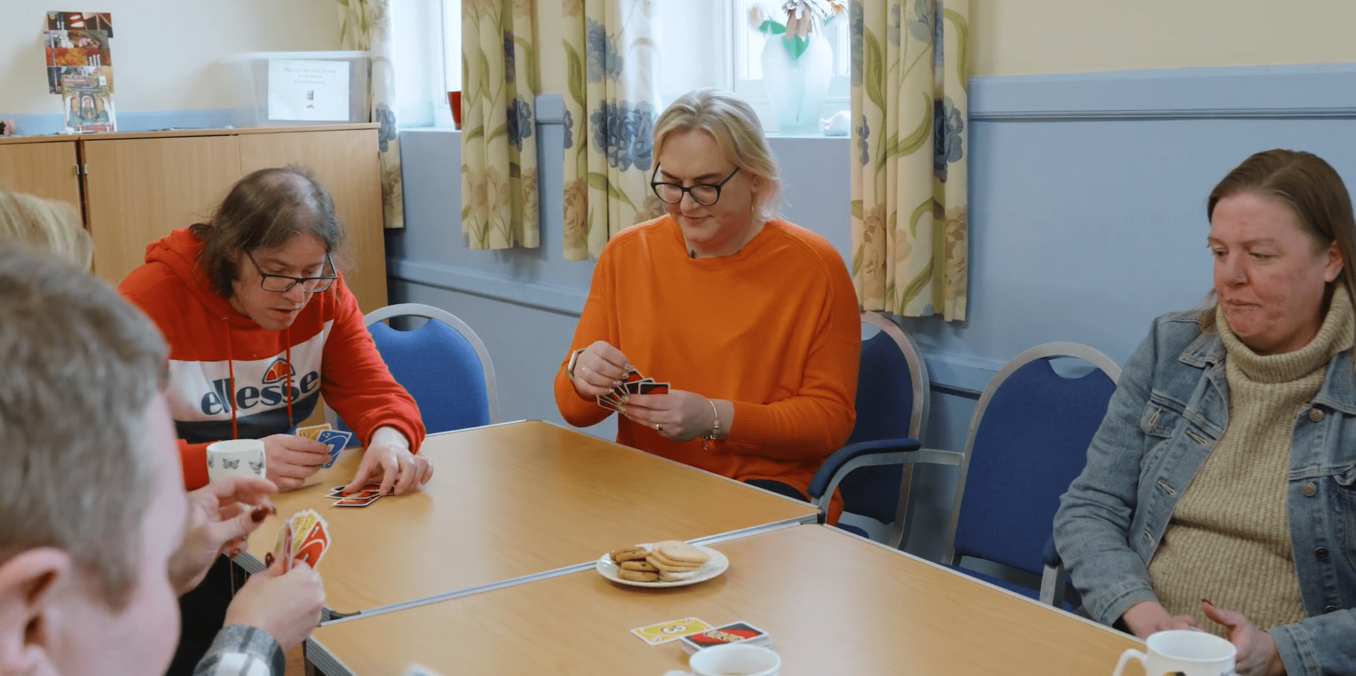 Lee Gilbert and others in the community play a fun game of Uno together