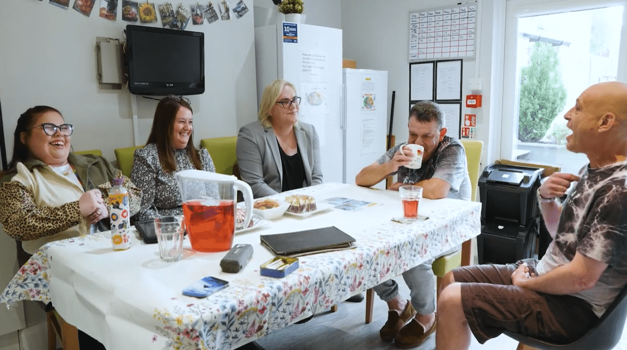At Springvale, a group of people laugh together at the table